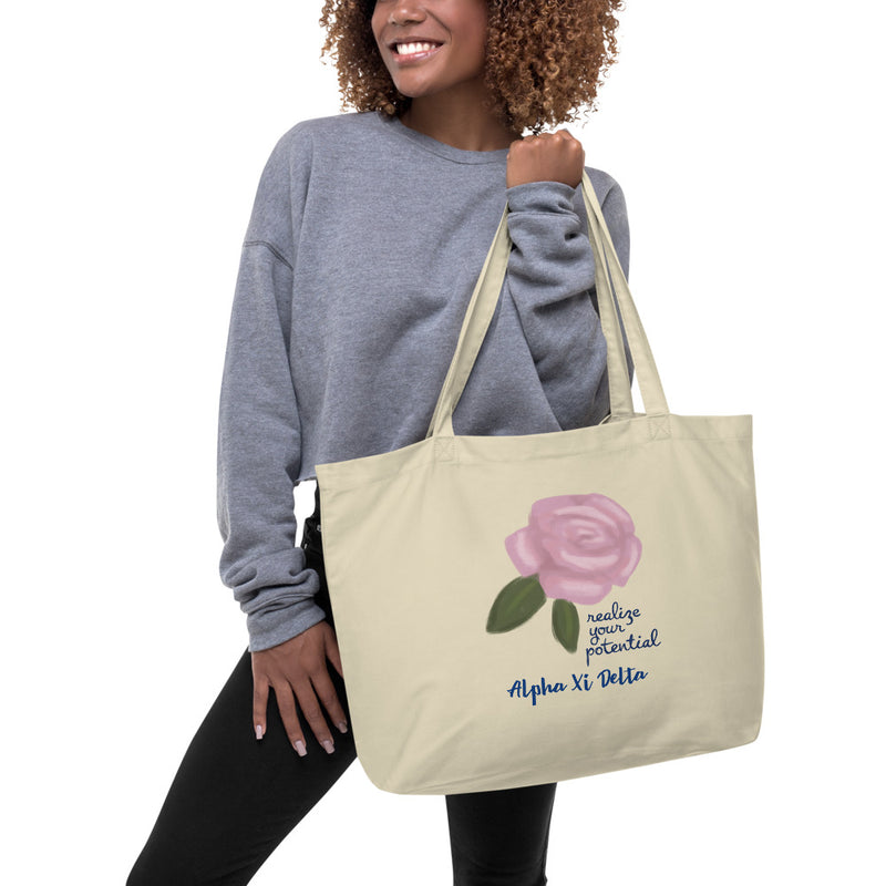 Alpha Xi Delta Realize Your Potential Large Organic Eco Tote Bag shown in natural color on model&