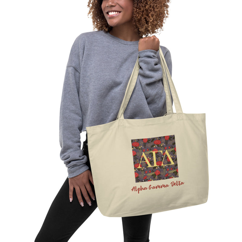 Alpha Gamma Delta Greek Letters Large Organic Tote Bag in natural oyster color on model&