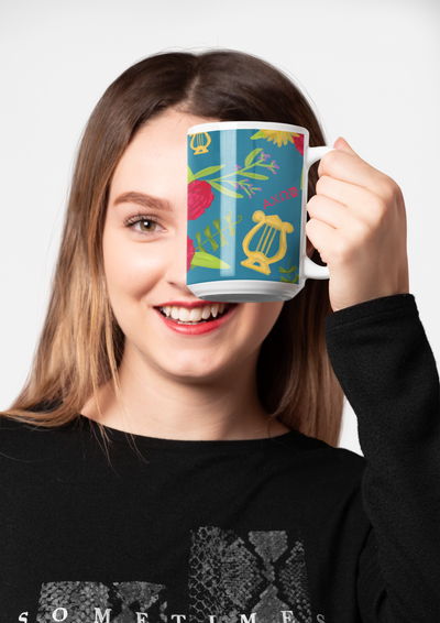 Alpha Chi Omega Floral Print Teal Glossy Mug shown in f15 oz size in front of woman's face 