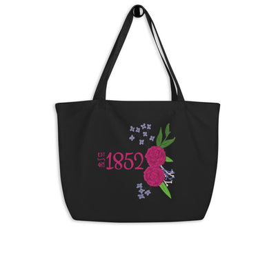 Phi Mu 1852 Organic Tote Bag shown in black hanging on a hook 
