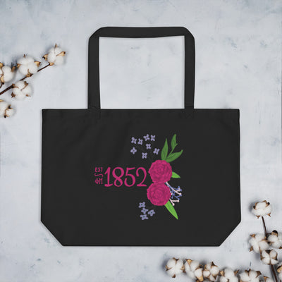 Phi Mu 1852 Tote Bag shown in black laying flat with cotton blossoms