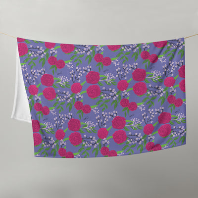 Phi Mu Carnation Floral Print Throw Blanket, Purple shown on clothesline