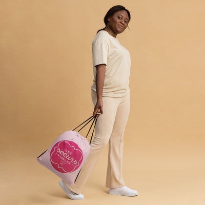 Phi Mu Motto Pink Drawstring Bag on model's hands