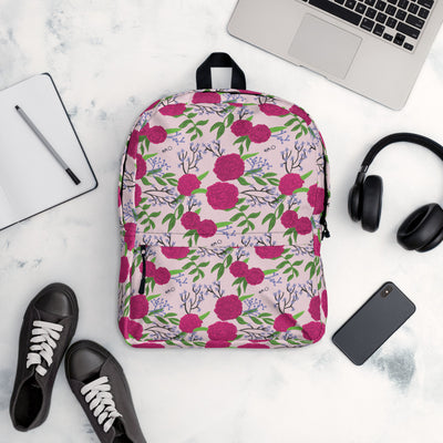 Phi Mu Carnation Floral Print Backpack in light pink shown in lifestyle setting