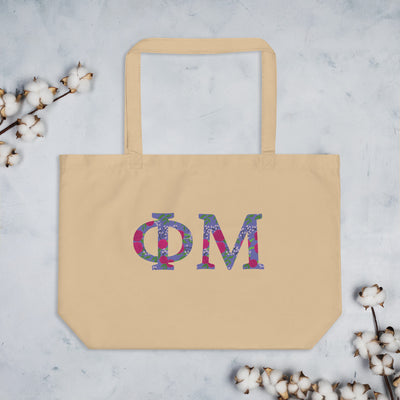 Phi Mu Filled Letters Tote Bag in natural oyster shown with cotton blossoms