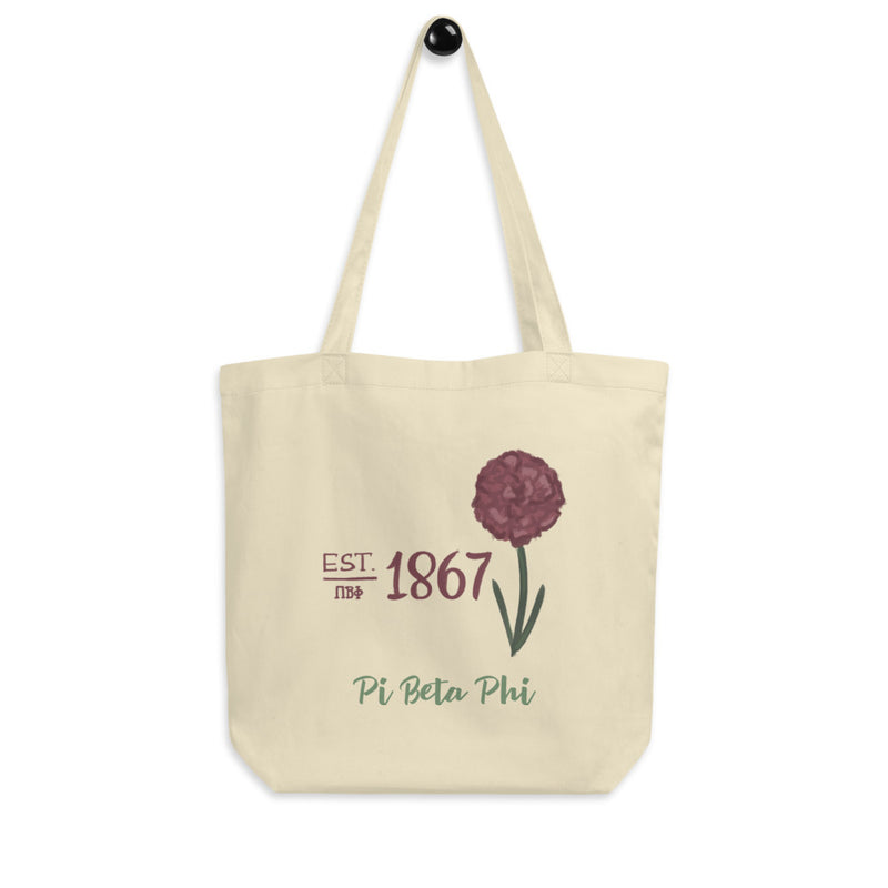 Pi Beta Phi 1867 Eco Tote Bag in natural oyster shown hanging on a hook