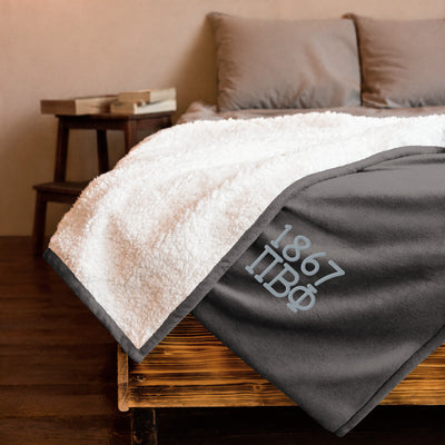 Pi Phi 1867 Plush Embroidered Sherpa Blanket in gray on bed