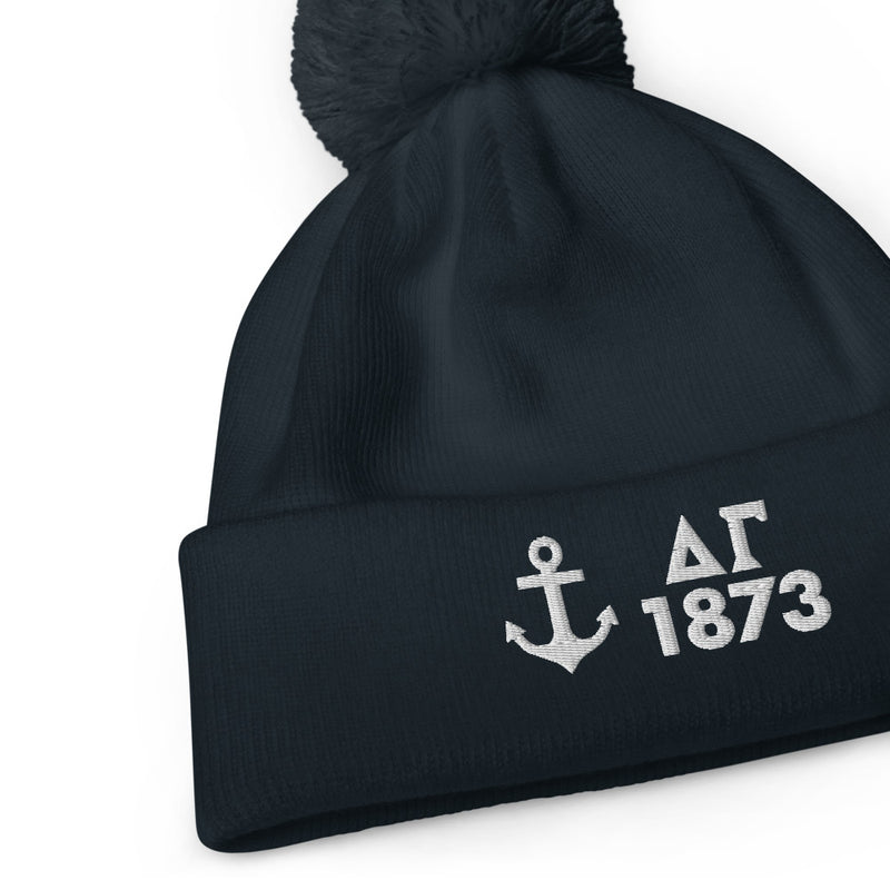 Delta Gamma Anchor 1873 Pom Pom Beanie shown in Navy blue with white embroidery