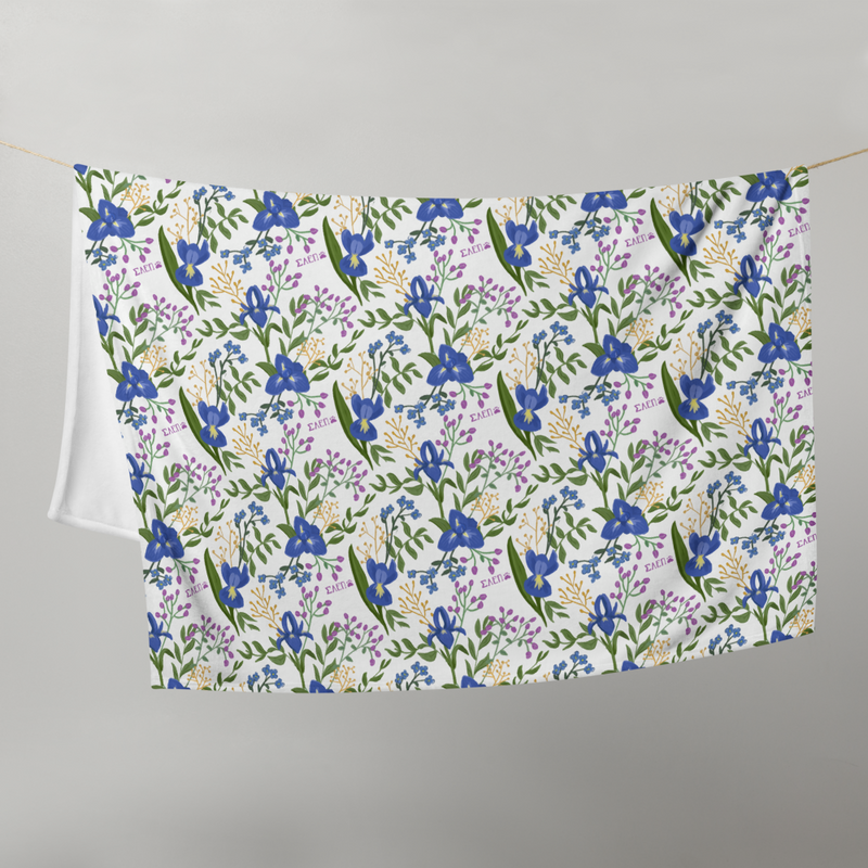 Sigma Alpha Epsilon Pi Floral Print Throw Blanket in white shown hanging on a clothesline