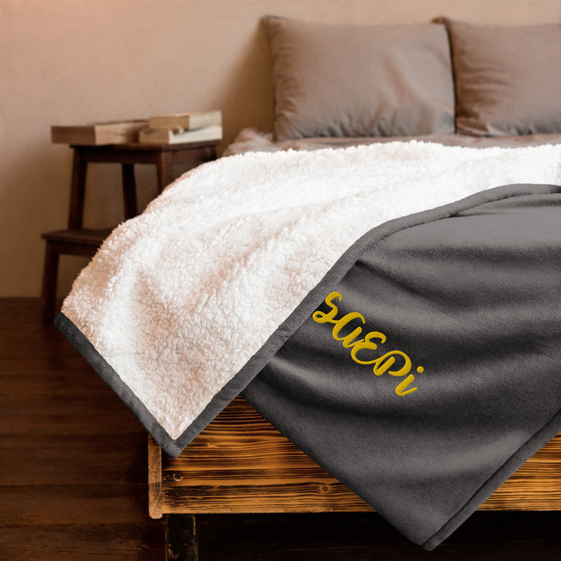 Sigma Alpha Epsilon Pi Embroidered Sherpa Blanket in gray on bed