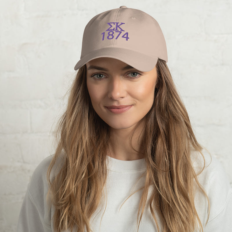 Sigma Kappa 1874 baseball cap in stone embroidered in purple with Sig Kap letters and founding year shown on model&