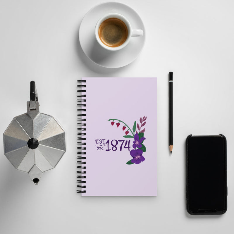 Sigma Kappa 1874 Spiral Notebook in lavender shown in lifestyle setting