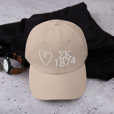 sigma kappa embroidered baseball hat in stone with white embroidery shown in lifestyle setting