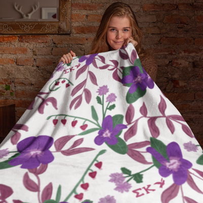 Sigma Kappa Violet Floral Print Blanket in white with violet floral print shown with model