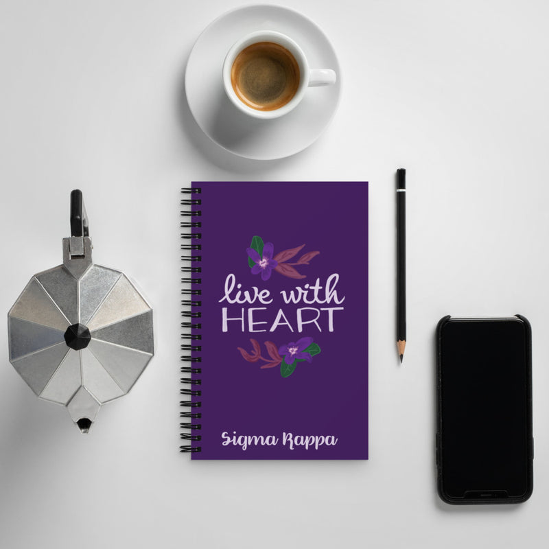 Sigma Kappa Live With Heart Notebook shown in lifestyle setting with coffee