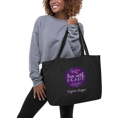 Sigma Kappa Motto Tote Bag in black shown on model's arm