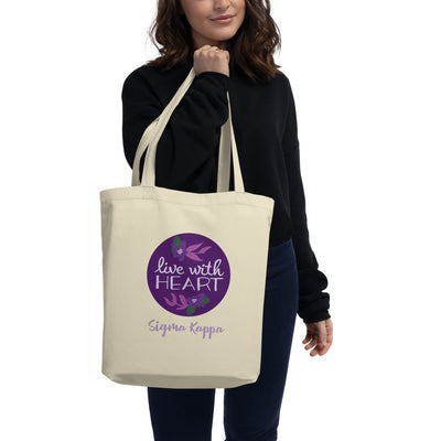 Sigma Kappa Motto Tote Bag in natural oyster shown on model's arm