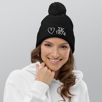 Sigma Kappa Pom Pom Beanie in black with white embroidery shown on model's head