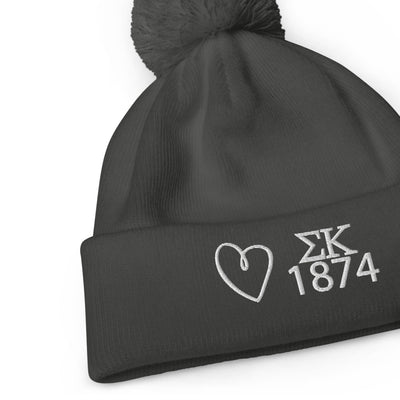 Sigma Kappa Pom Pom Beanie in graphite gray with white embroidery shown flat 