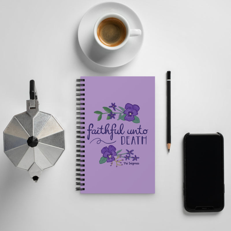 Tri Sigma Faithful Unto Death Spiral Notebook shown with coffee