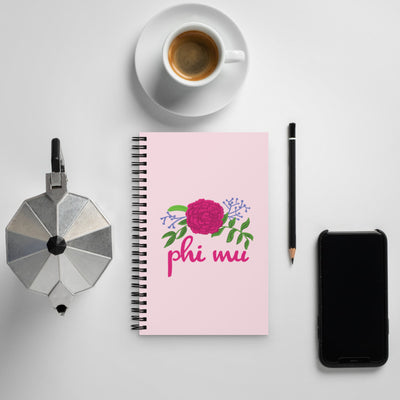 Phi Mu Carnation Design Spiral Notebook shown with coffee