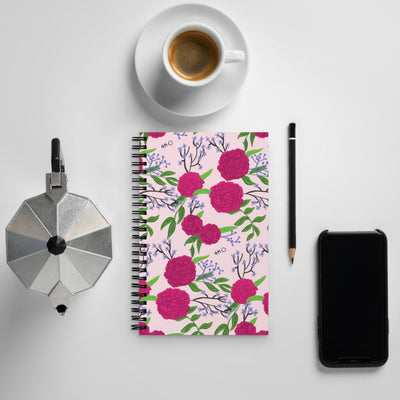 Phi Mu Pink Carnation Print Pink Spiral Notebook shown with coffee