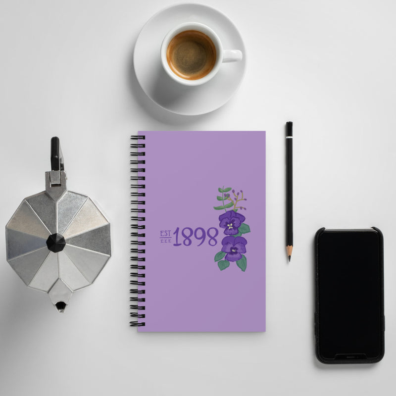Tri Sigma 1898 Founding Year Spiral Notebook shown with coffee