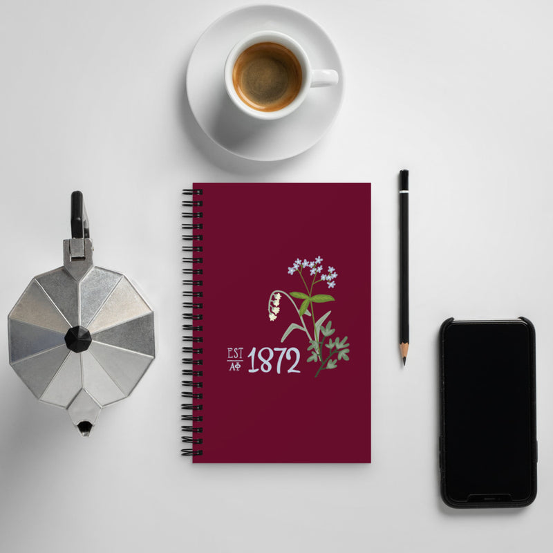 Alpha Phi 1872 Founding Year Spiral Notebook shown with coffee