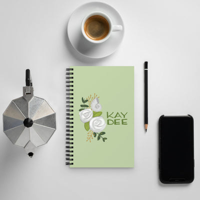 Kappa Delta Kay Dee Rose and Nautilus Spiral Notebook shown with coffee
