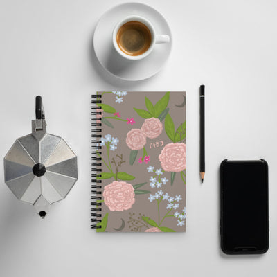Gamma Phi Beta Pink Carnation Print Spiral Notebook shown with coffee