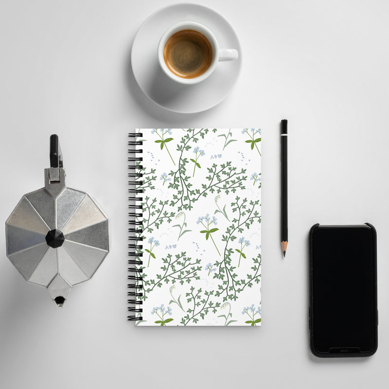 Alpha Phi Lily Floral Print Spiral Notebook, White shown with coffee