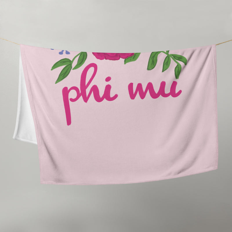 Phi Mu Carnation Design Pink Throw Blanket shown on clothesline