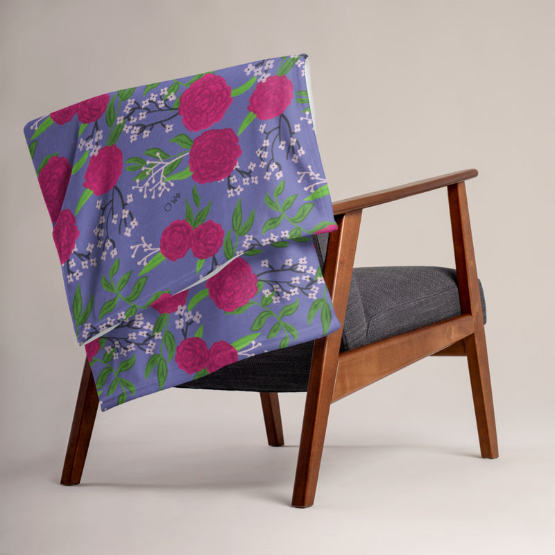 Phi Mu Carnation Floral Print Throw Blanket, Purple shown on chair