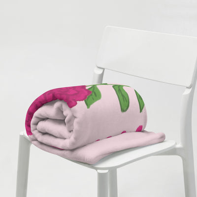 Phi Mu Carnation Design Pink Throw Blanket folded on chair