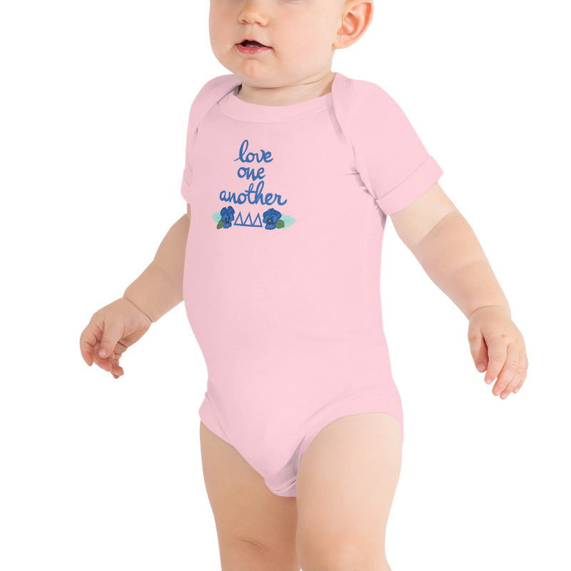 Tri Delta Love One Another Baby Onesie in pink