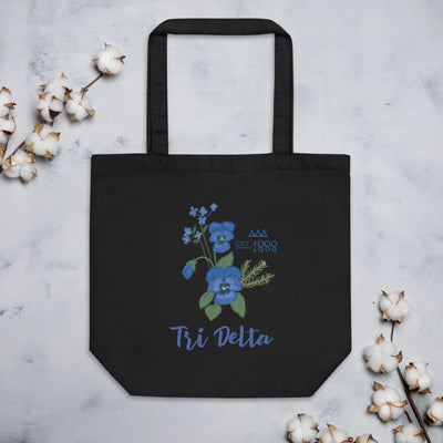 Tri Delta Sorority Tote Bag in black shown flat with cotton blossoms