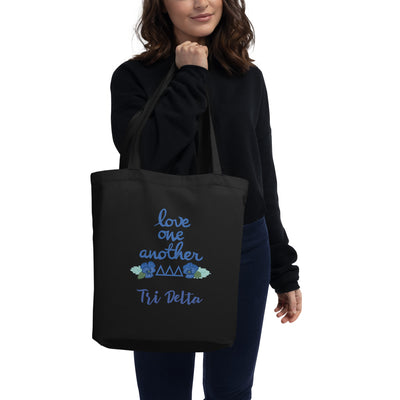 Tri Delta Sorority Tote Bag shown in black with Love One Another design on model's arm