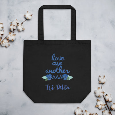 Tri Delta Sorority Tote Bag in black shown flat with cotton blossoms