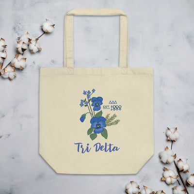 Tri Delta Sorority Tote Bag in natural oyster color shown with cotton blossoms