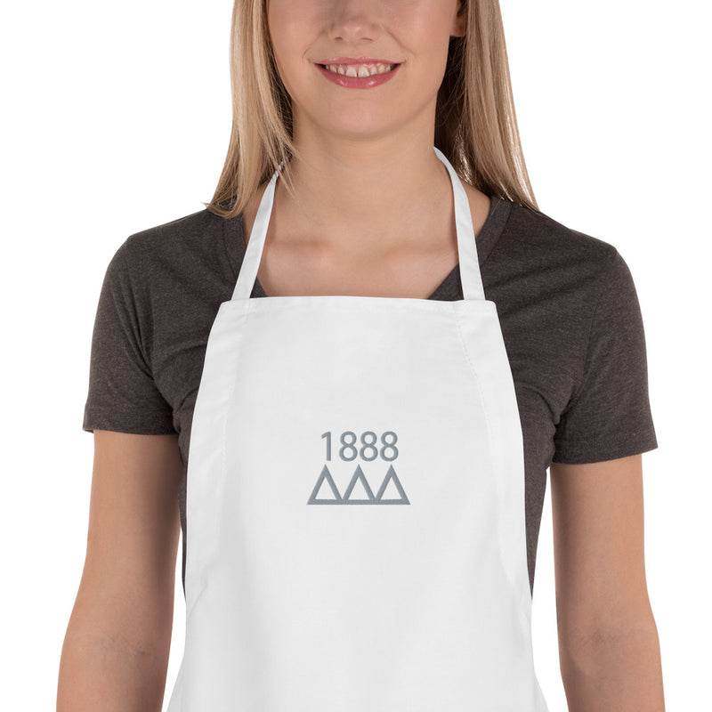 Tri Delta 1888 Sorority Apron in white with silver embroidery shown in detail view on model