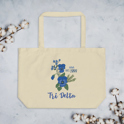 Tri Delta Large Sorority Tote Bag in natural shown flat with cotton blossoms