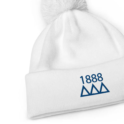 Tri Delta Sorority Pom Pom Beanie in white with Navy blue embroidery shown close up