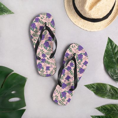 Tri Sigma violet floral flip flops in lifestyle setting