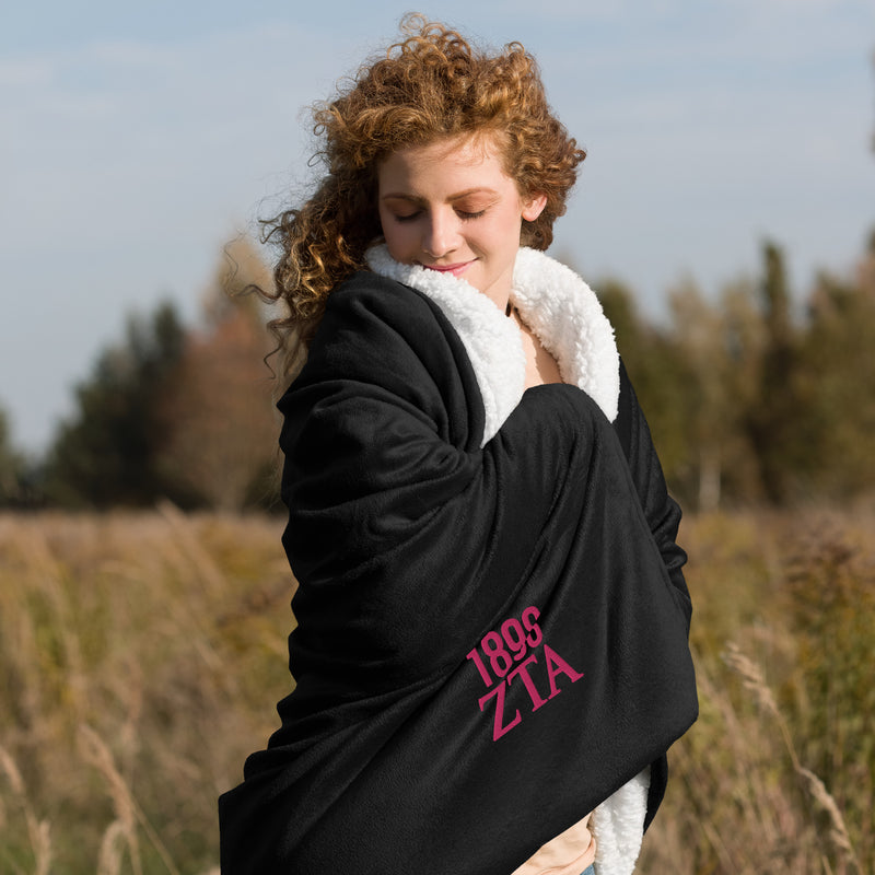 Zeta Tau Alpha 1898 Sherpa Blanket in black shown with model