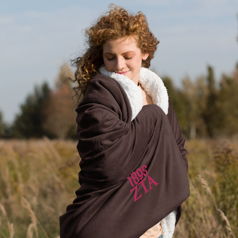 Zeta Tau Alpha 1898 Sherpa Blanket in brown shown with model