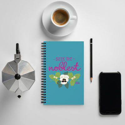 Zeta Tau Alpha Motto Notebook in Turquoise shown in lifestyle setting