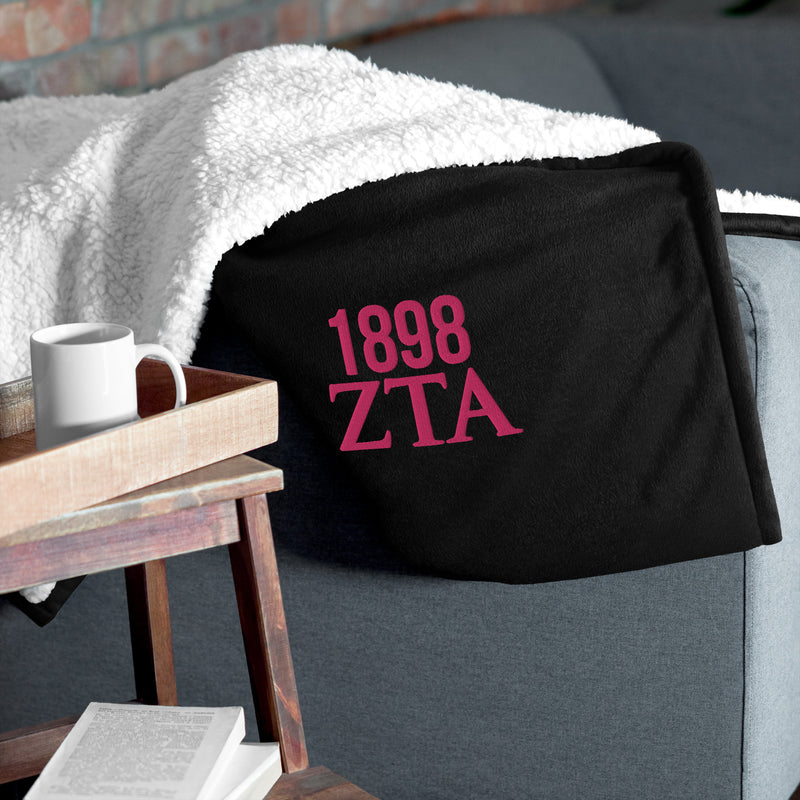 Zeta Tau Alpha 1898 Sherpa Blanket in black on couch